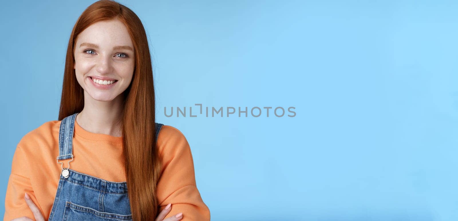 Lifestyle. Young stylish confident smiling female redhead freelancer assured job done great grinning satisfied hold hands crossed chest self-assured standing blue background good mood upbeat attitude.