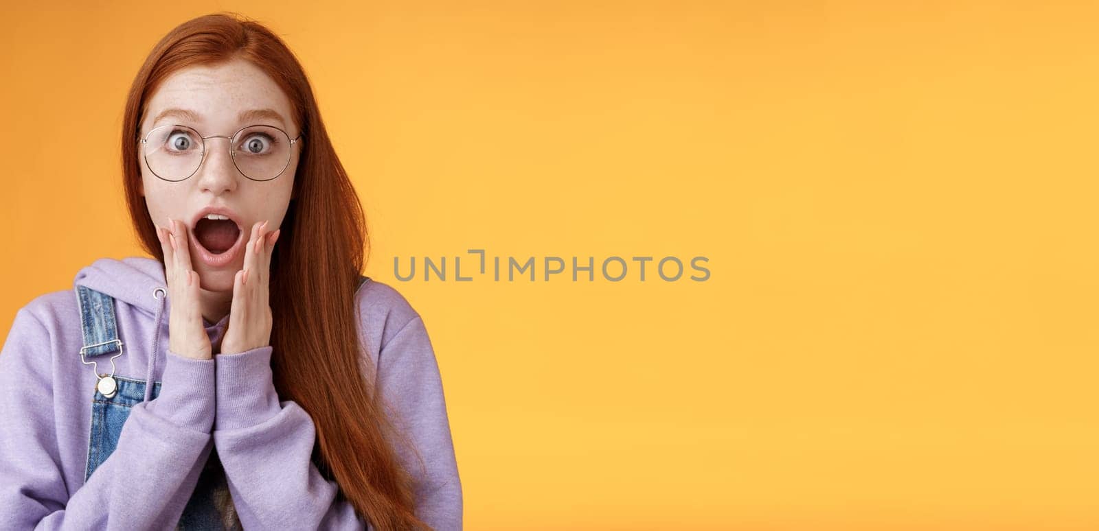 Shocked impressed redhead girlfriend drop jaw gasping screaming wow omg touch cheek near mouth wide eyes surprised reacting astonishing news fresh rumors gossiping amazed, orange background by Benzoix