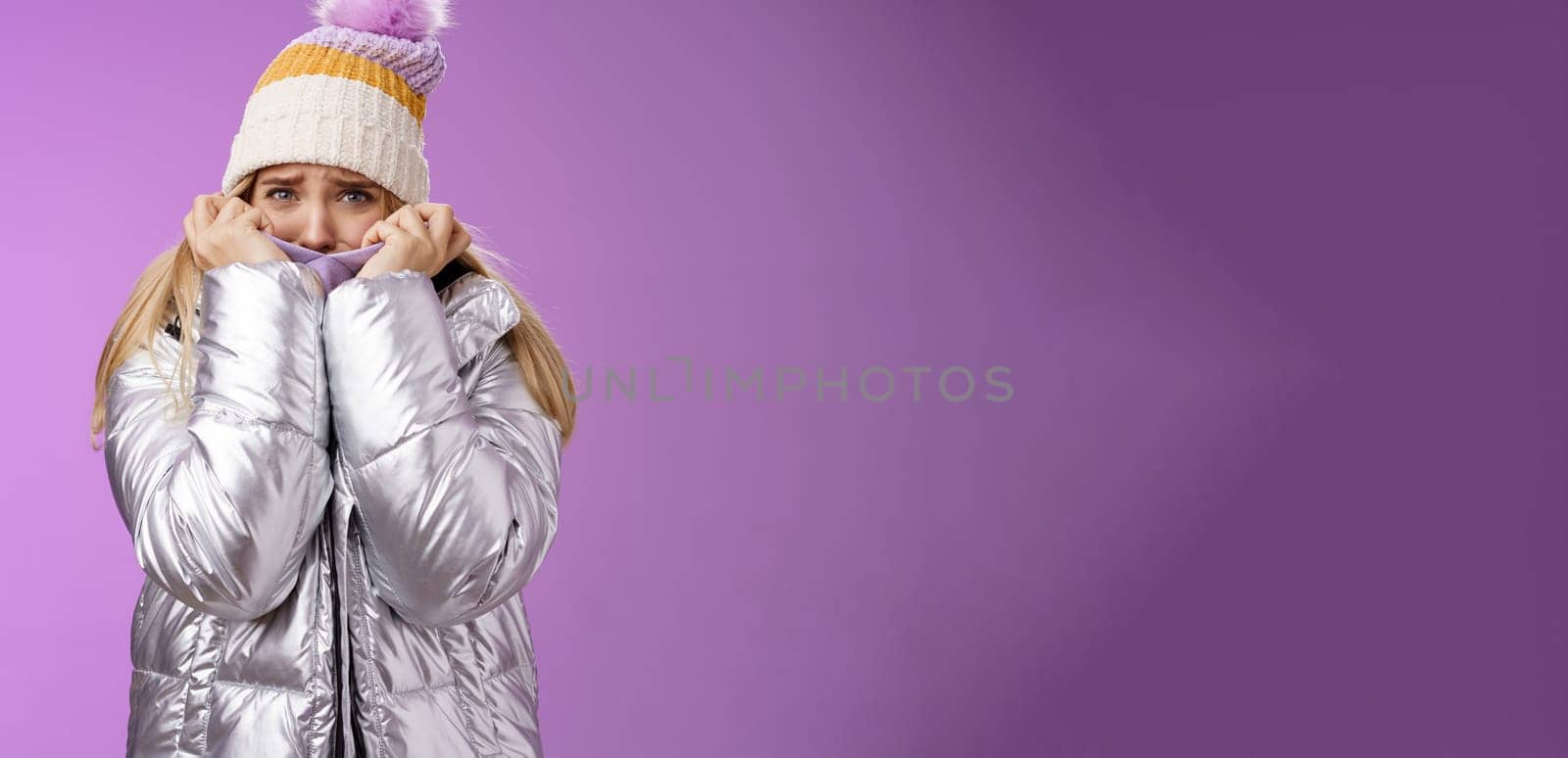 Scared afraid insecure coward girl in cute hat glittering shiny jacket pull cloth face frightened frowning stooping look concerned terrified scared death, standing purple background timid by Benzoix