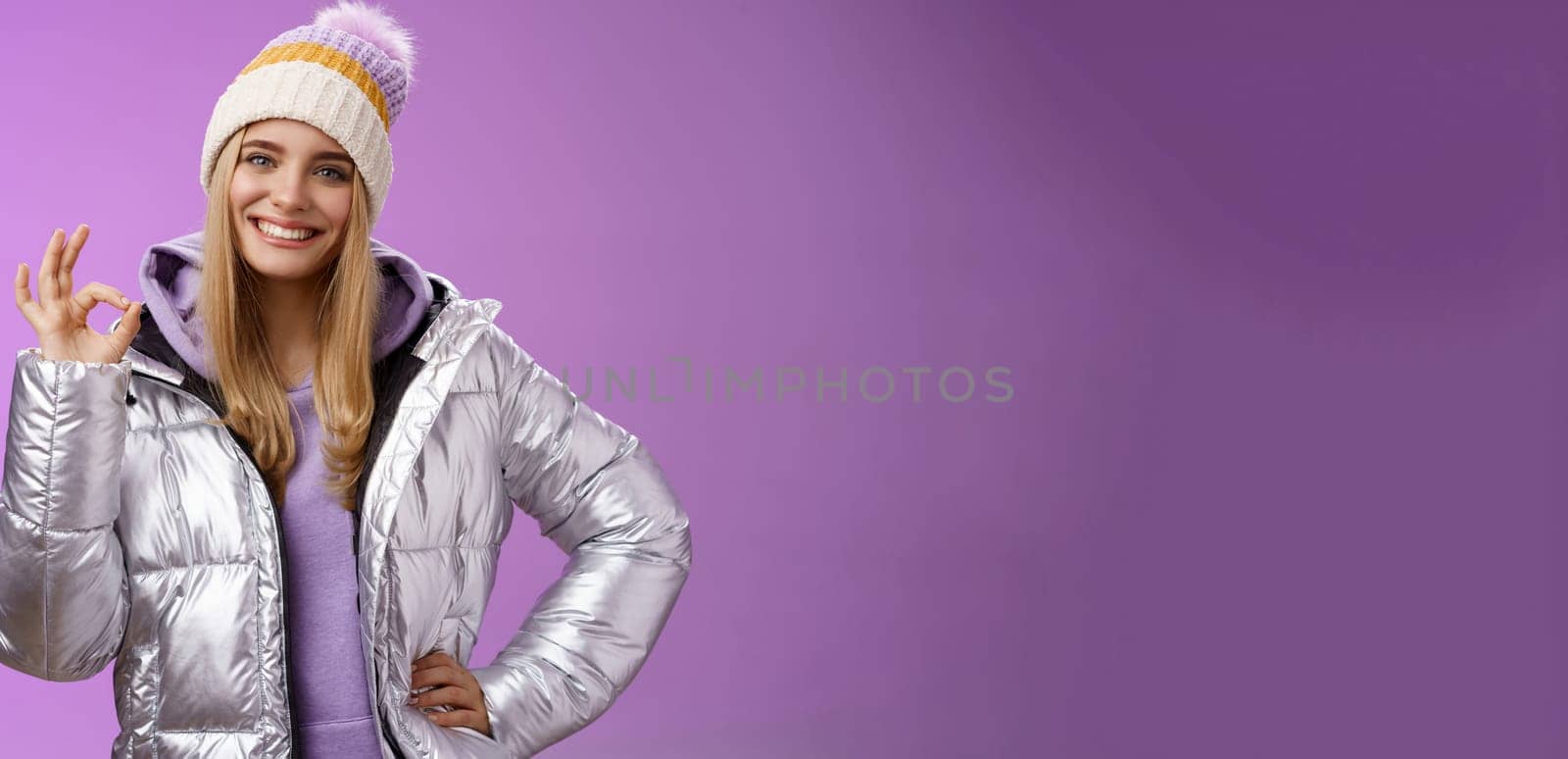 Got it count done. Portrait confident assertive charming smiling blond girl give okay assure everything perfect grinning delighted recommend awesome hotel standing self-assured purple background by Benzoix