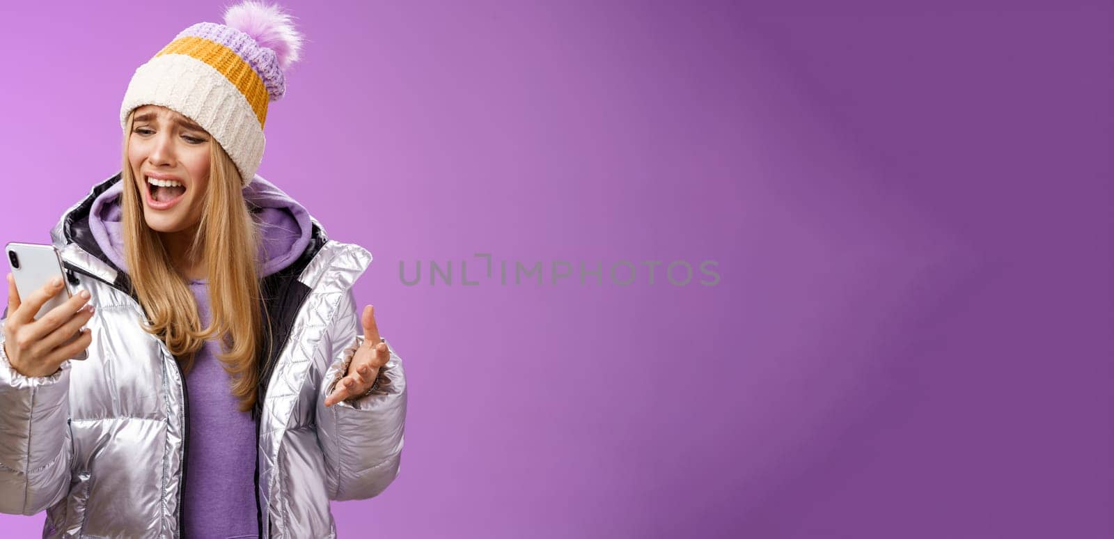 Bothered complaining dissatisfied cute blond girl yelling stupid smartphone standing unhappy recording audio message whining yelling mobile phone upset, standing purple background by Benzoix