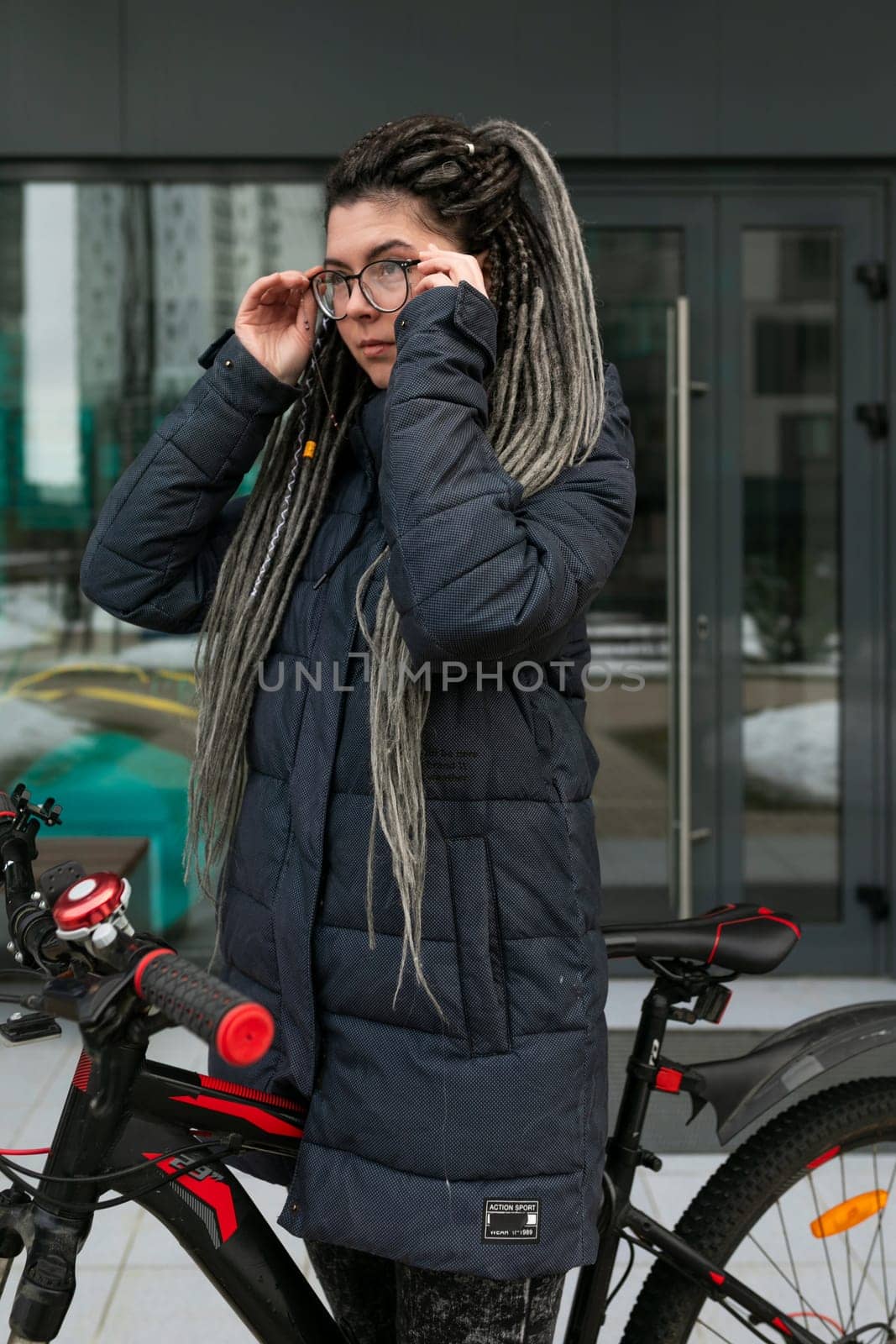 Photo on the street, a young woman took her bike for a walk in winter by TRMK