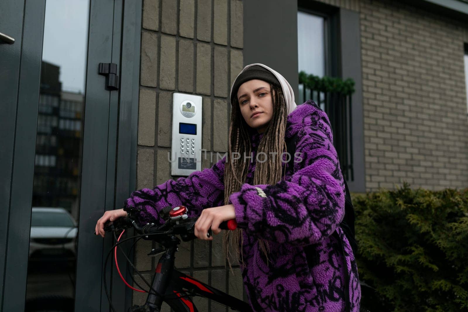 Bicycle rental concept. Young woman riding a sports bike around the city.