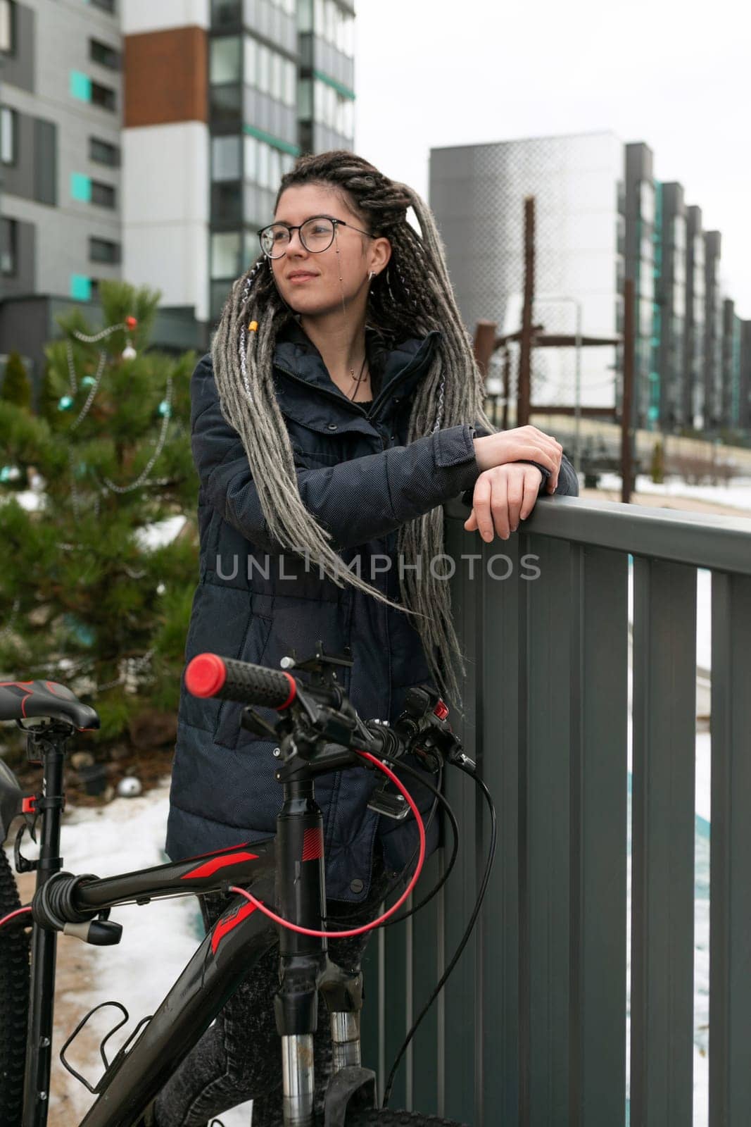 Bike rental concept, young european woman riding a bike around the city.