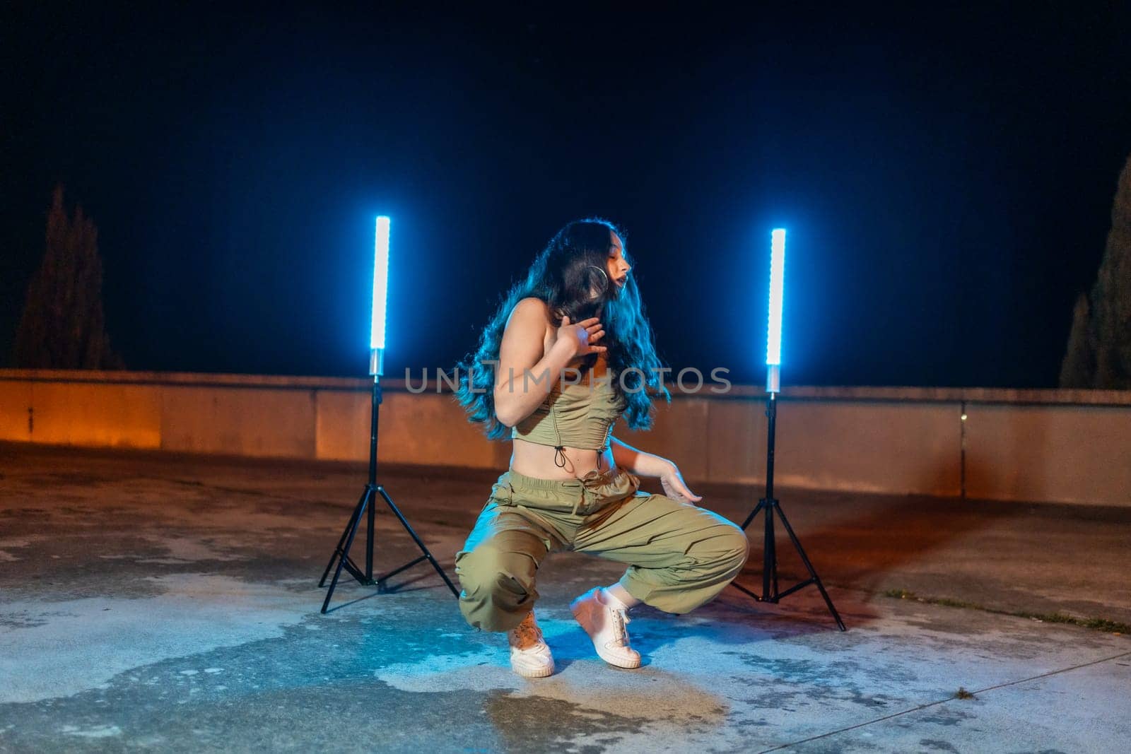 Sensual dancer dancing trap modern music outdoors at night by Huizi