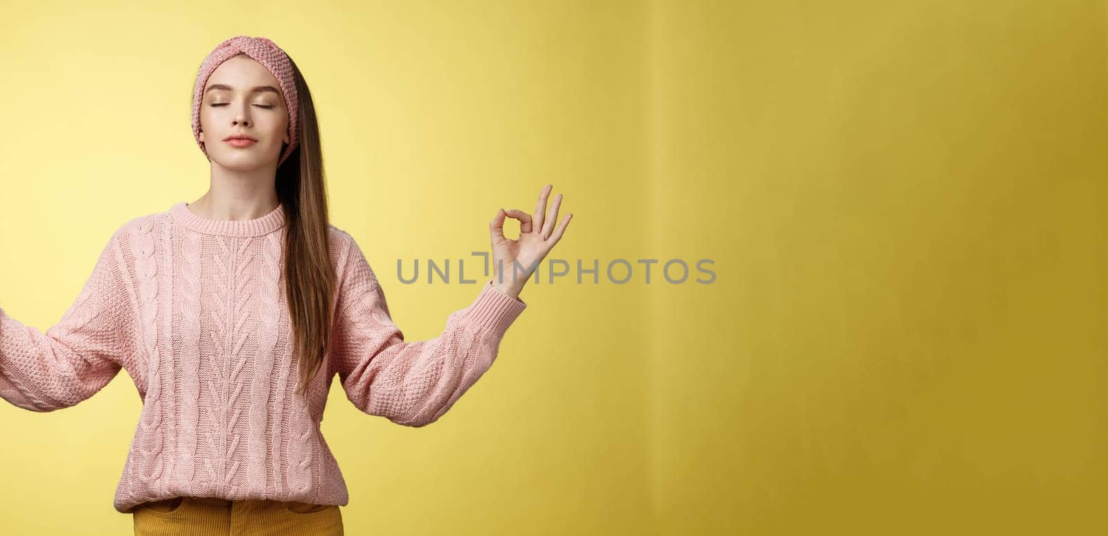 No stress. Pretty young female student not worry, releasing negative emotions during yoga training session standing in lotus pose, breathing smiling relieved happy, showing mudra sign feeling relaxed by Benzoix