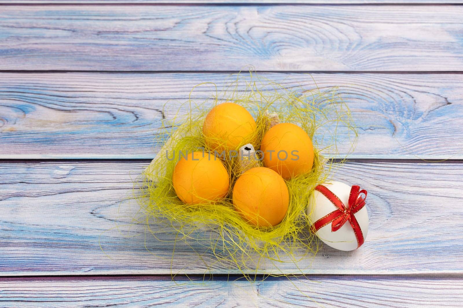 Easter eggs in a box on the wooden background by mvg6894