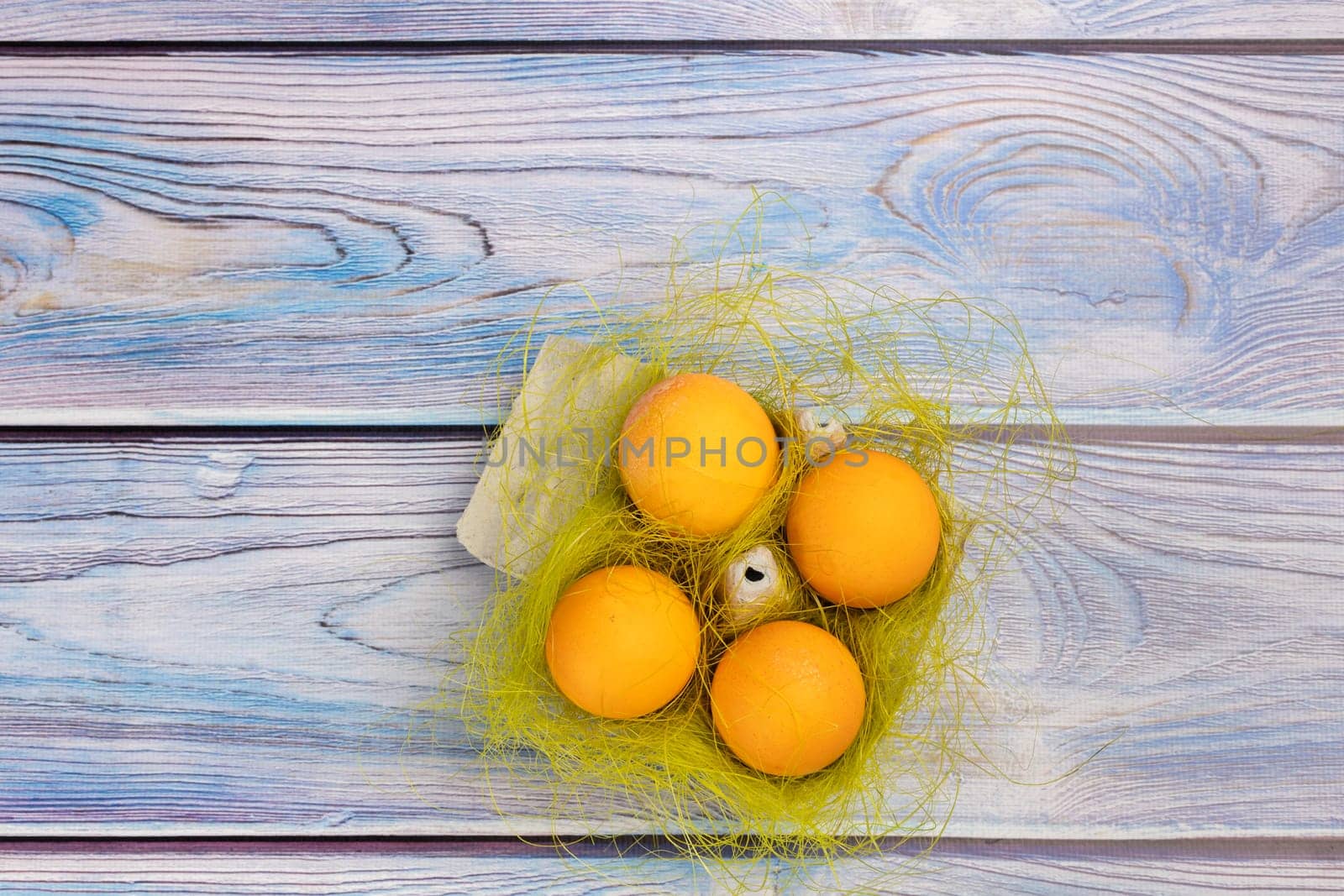 Easter eggs in a box on the wooden background. by mvg6894