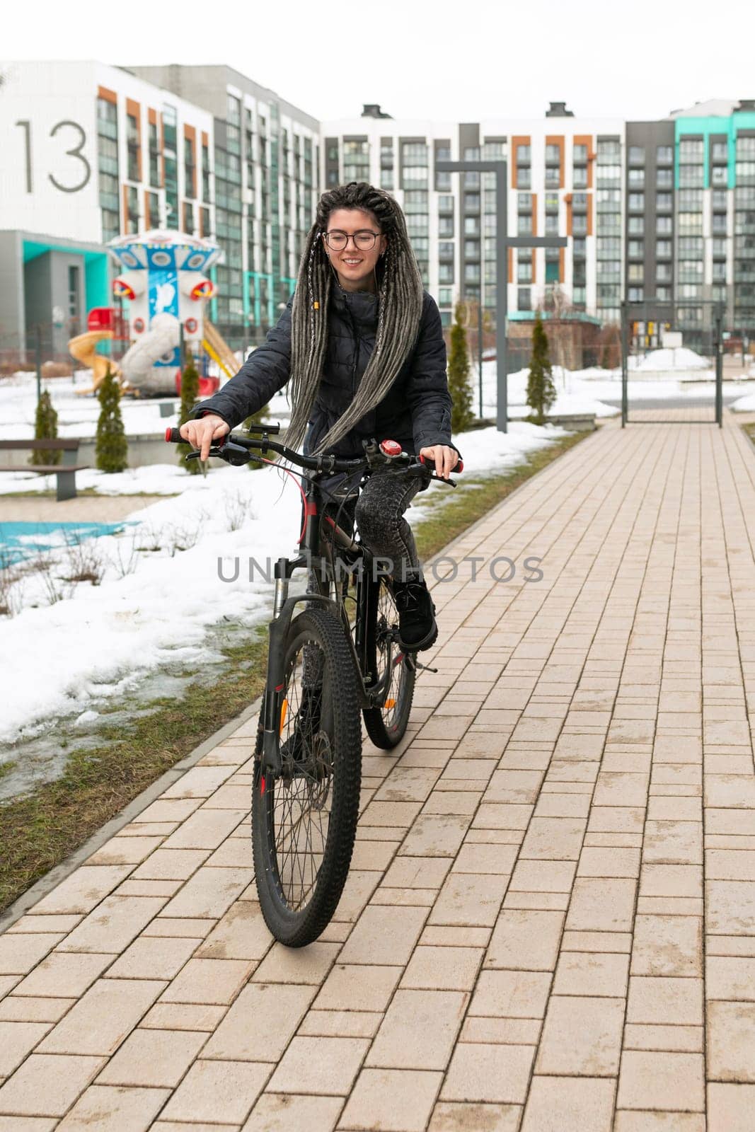Lifestyle concept, young European woman rides around the city on a bicycle.