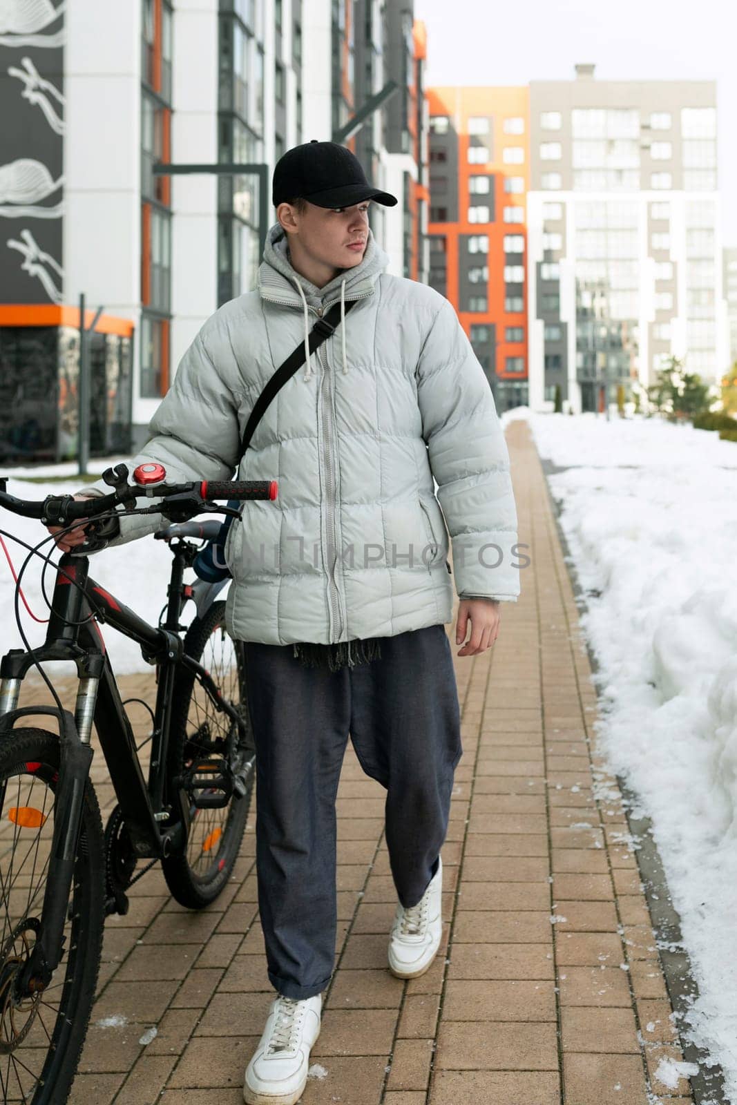 A young man in autumn clothes takes a bike ride by TRMK