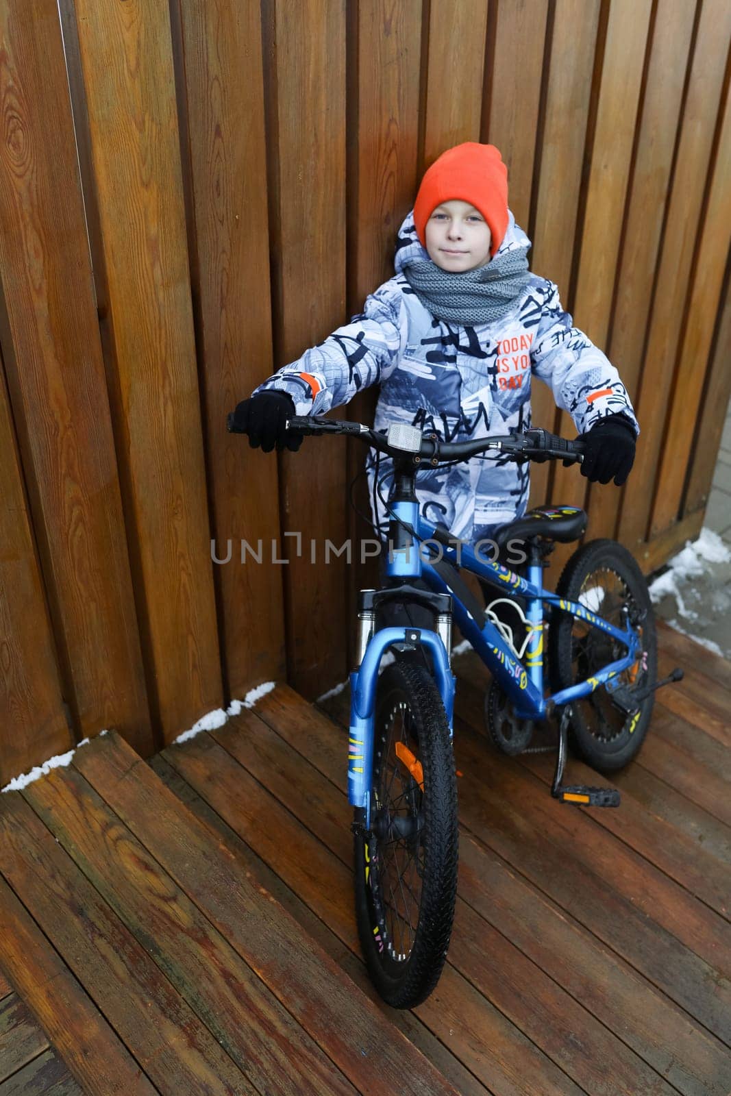 European child rented a bicycle in winter.