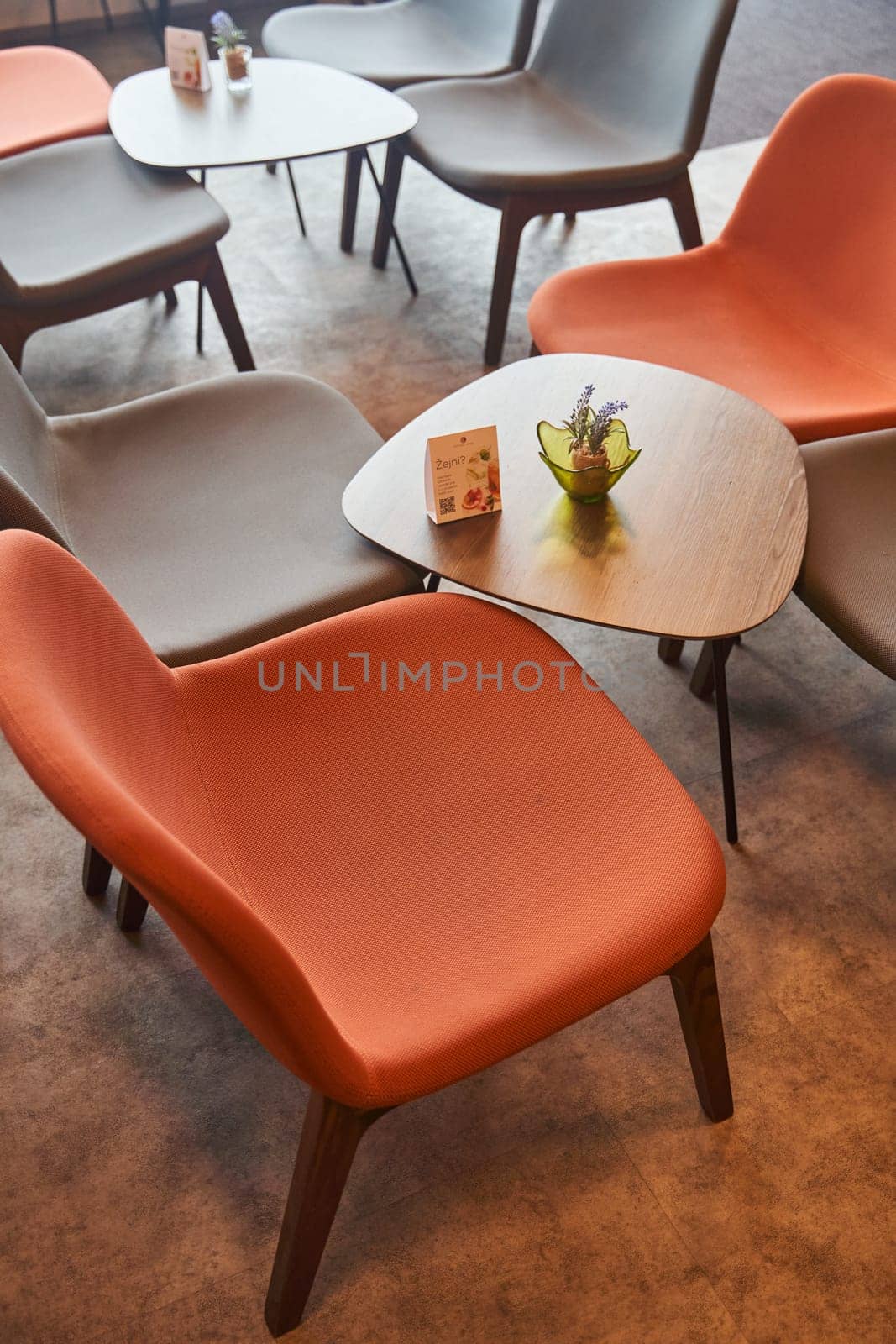 A set of wooden chairs and tables are arranged neatly in a room with hardwood flooring. The furniture adds a cozy touch to the house