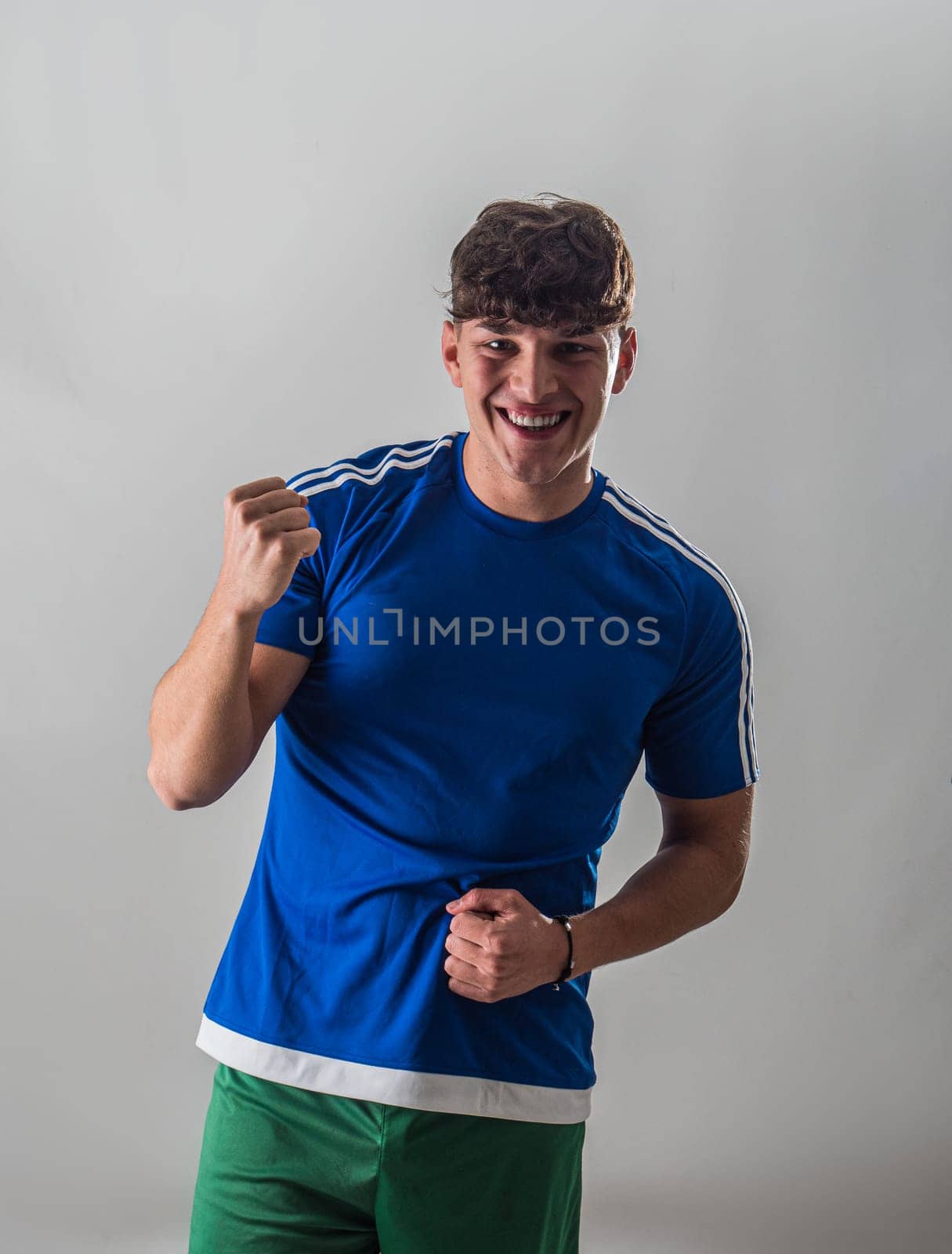 A man in a blue shirt and green shorts by artofphoto