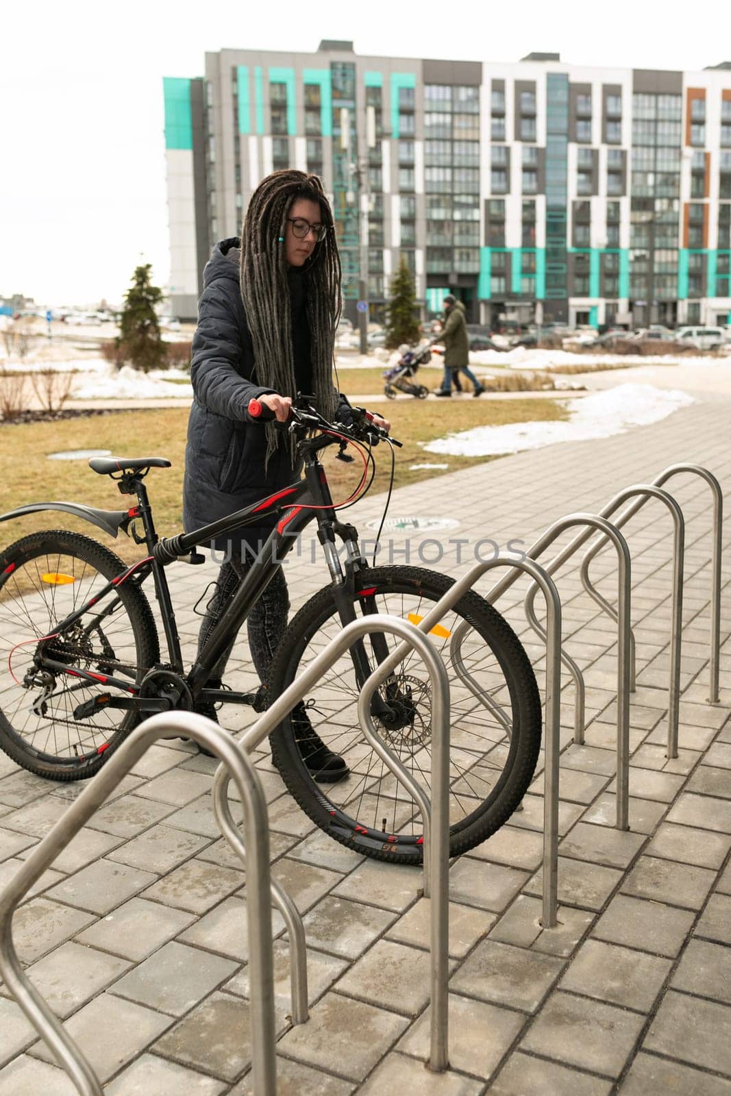 Urban pretty woman with bicycle in winter by TRMK