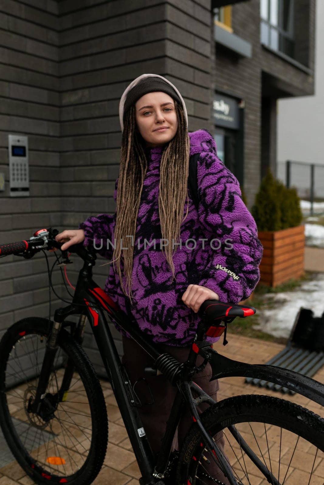 European stylish woman enjoys riding a bicycle by TRMK