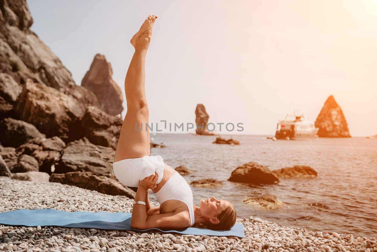 Woman sea yoga. Back view of free calm happy satisfied woman with long hair standing on top rock with yoga position against of sky by the sea. Healthy lifestyle outdoors in nature, fitness concept.