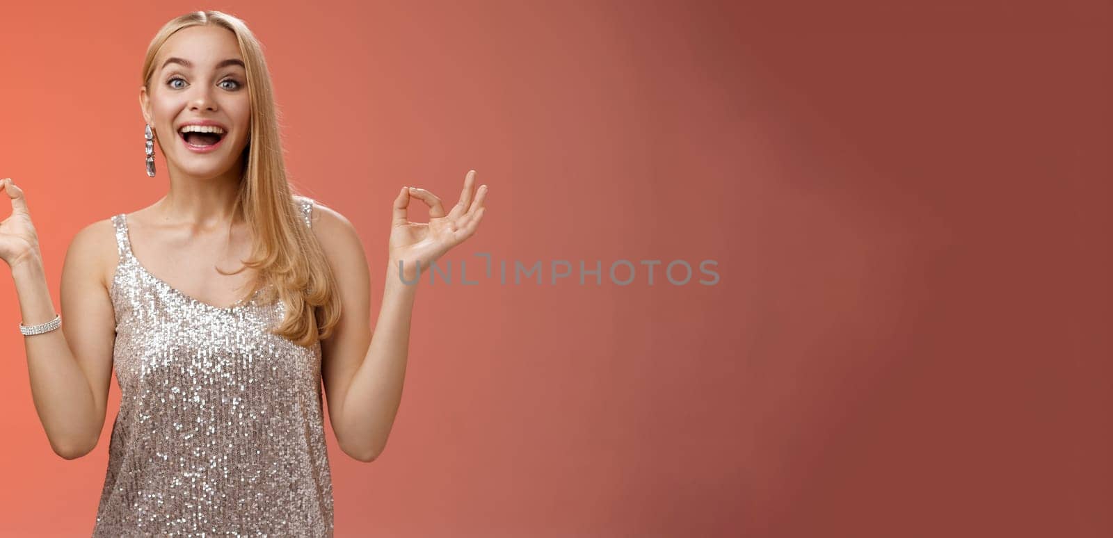 Excited carefree happy stress-free charming blond european woman calm feelings under control show zen gesture standing nirvana lotus pose meditating joyfully smiling, calmd-down red background.