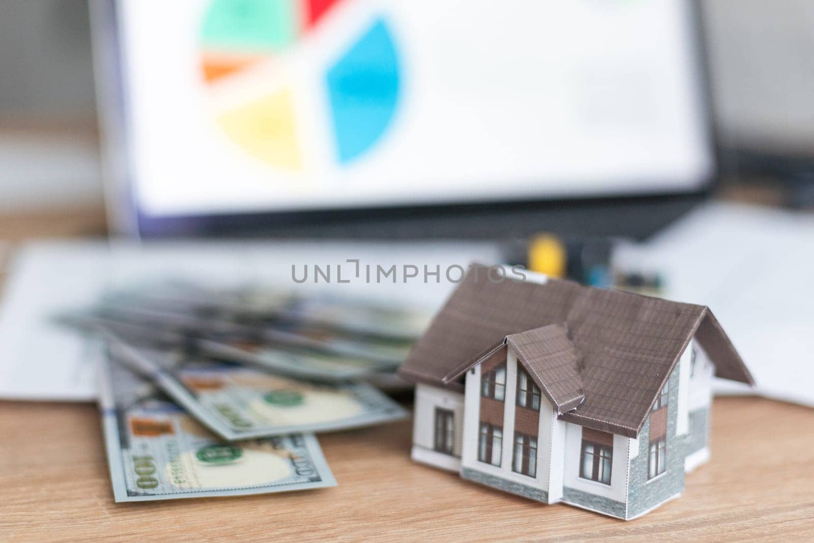 a toy house with banknotes, home insurance, mortgage, a symbol of material well-being. High quality photo