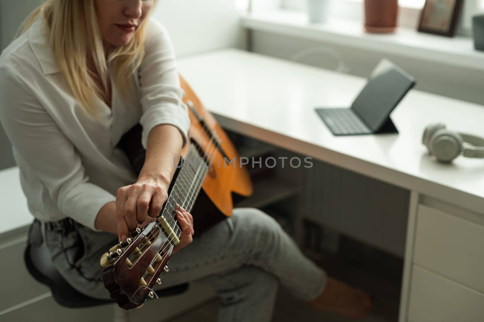 woman blogger live steam playing guitar on social media. High quality photo
