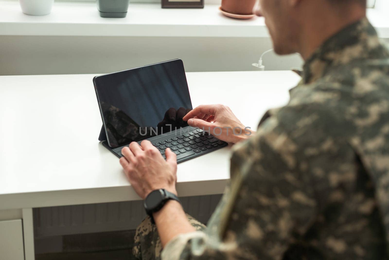 Happy soldier using laptop. Military service. High quality photo