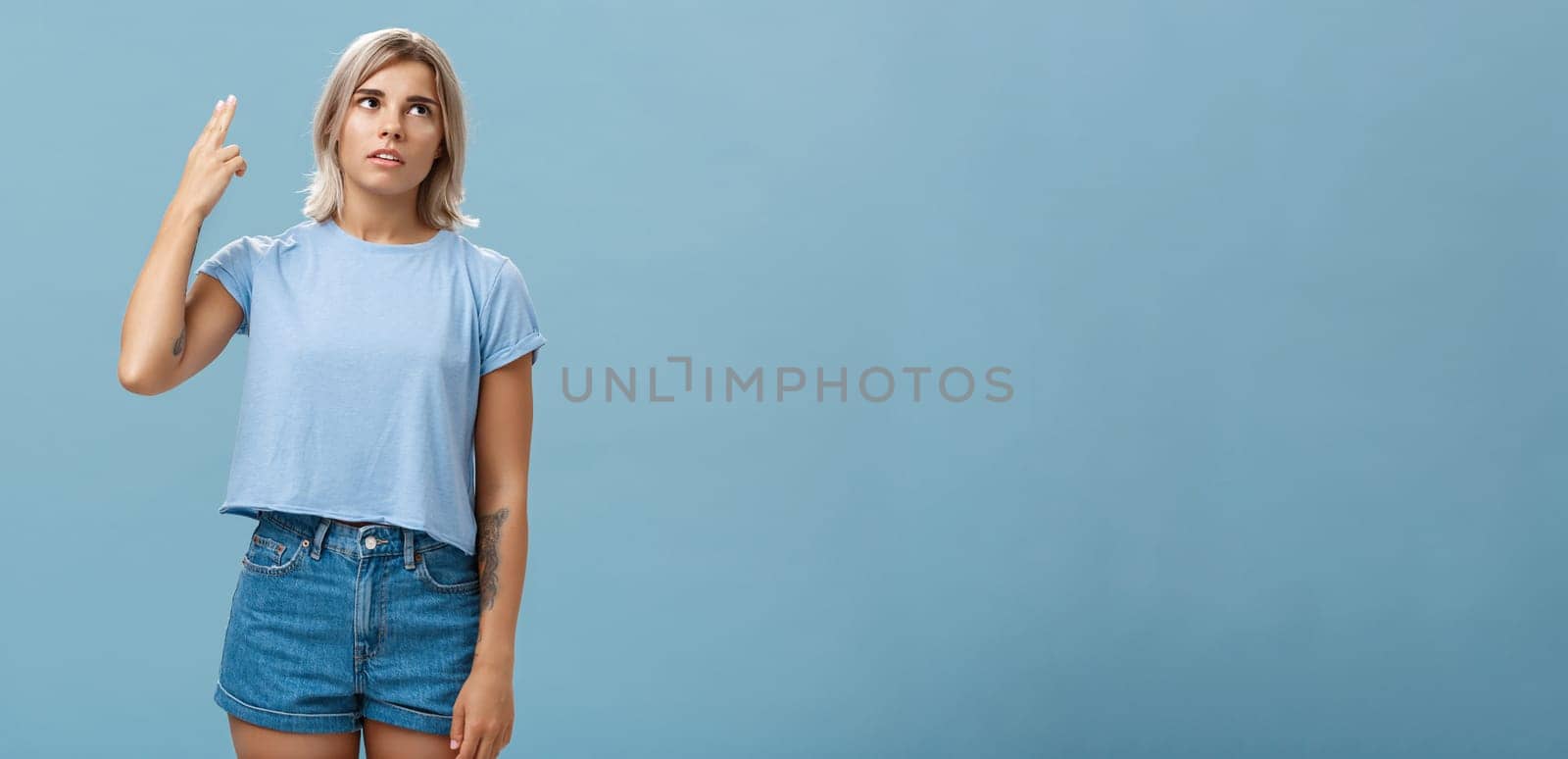 Stop teaching me how live my life. Portrait of irritated displeased attractive blonde female in denim shorts and casual t-shirt rolling eyelids from annoyance showing gun gesture as if blowing brains by Benzoix