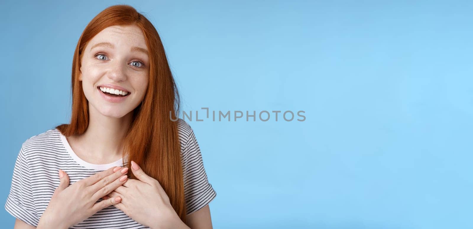 Kind fascinated touched romantic passionate redhead girl blue eyes sighing admiration delight touch heart palms smiling happily grinning grateful thanking friend express gratitude, studio background by Benzoix