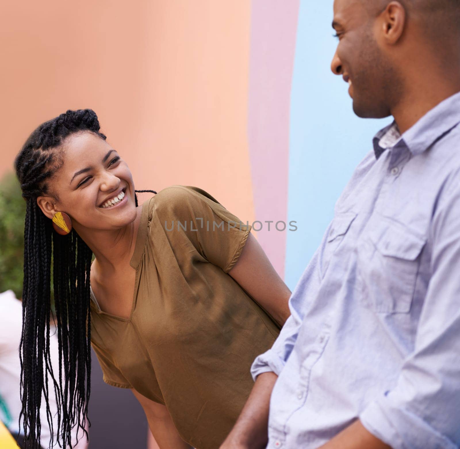 Outdoor, funny and couple with conversation, love and laugh with romance and bonding together. Happiness, man and woman with smile and discussion with peace and vacation with marriage or relationship by YuriArcurs