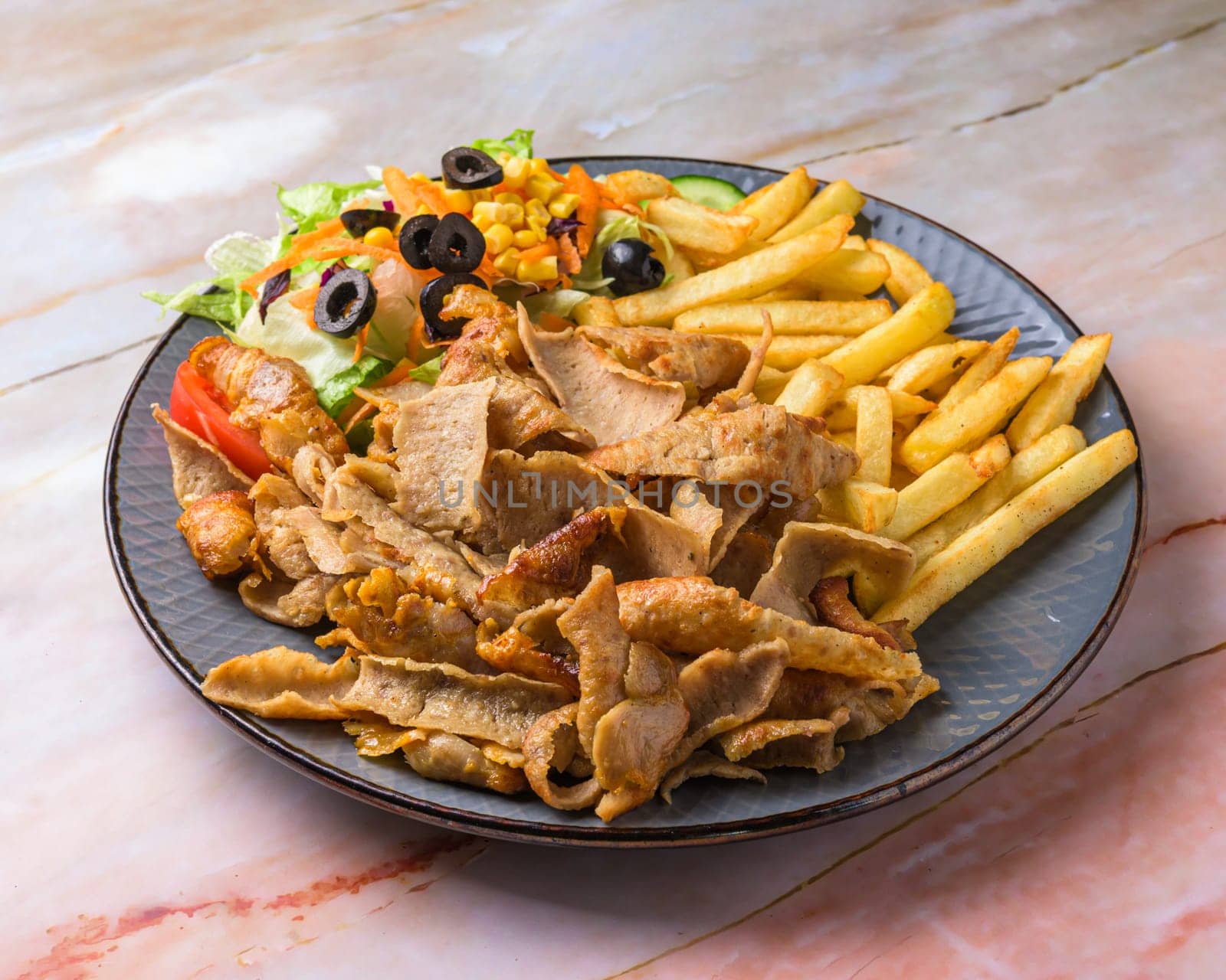 Chicken Shawarma plate with salad, fries served in a dish isolated on grey background side view of arabian fastfood,
