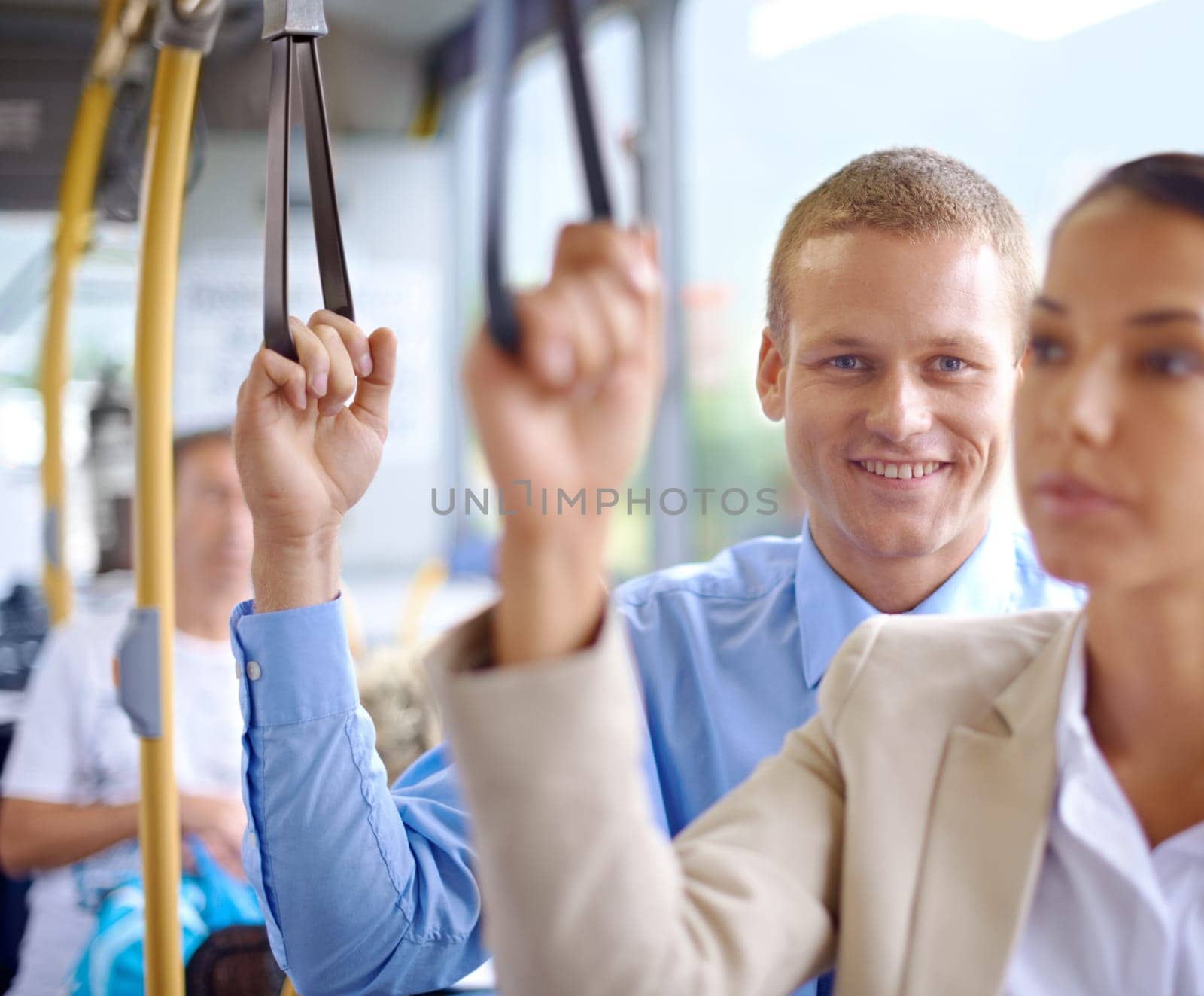 Man, happy and standing on public transportation or bus, journey and travel to work in city. Male person, smile and trip or transit on metro, traffic and passenger or standing in motor vehicle by YuriArcurs