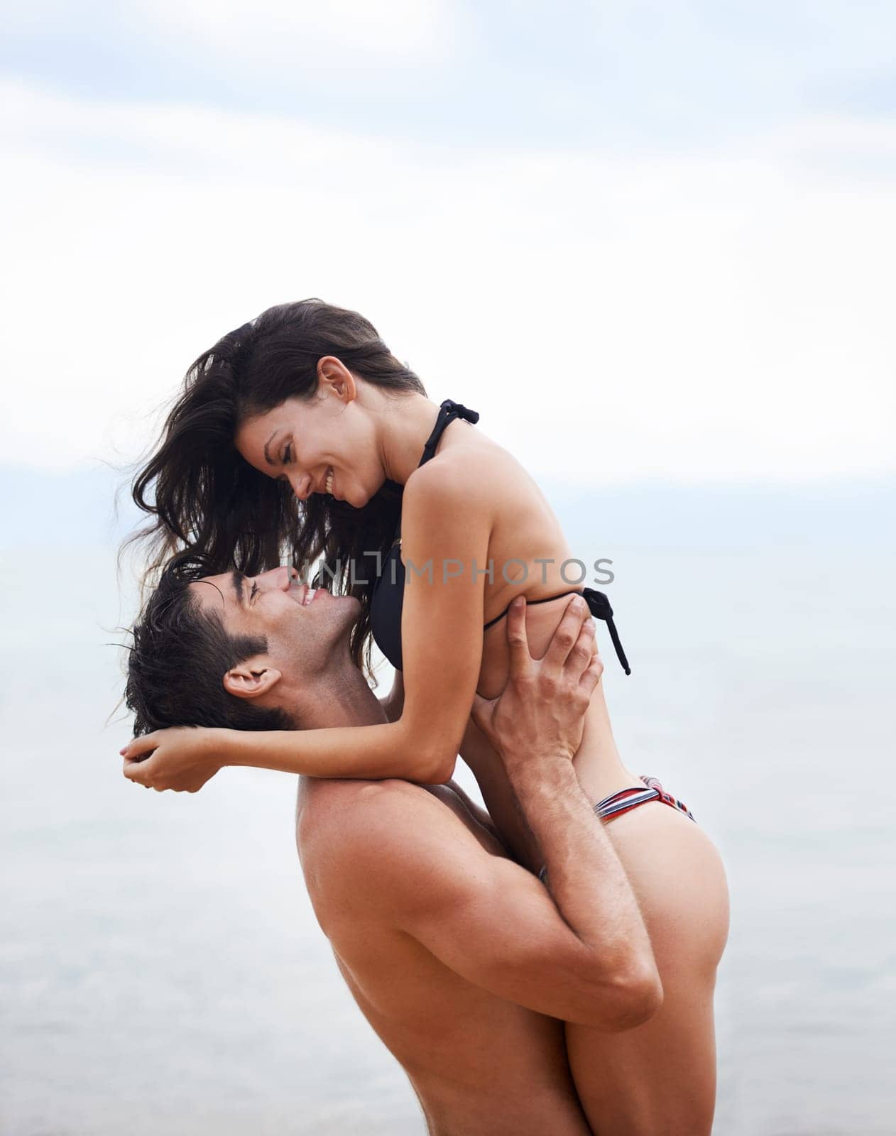 Couple, beach and ocean with love, smile and romance with swimwear and bikini. Man, woman and date with holiday, vacation and adventure with nature for cape town summer travel and happiness for trip by YuriArcurs