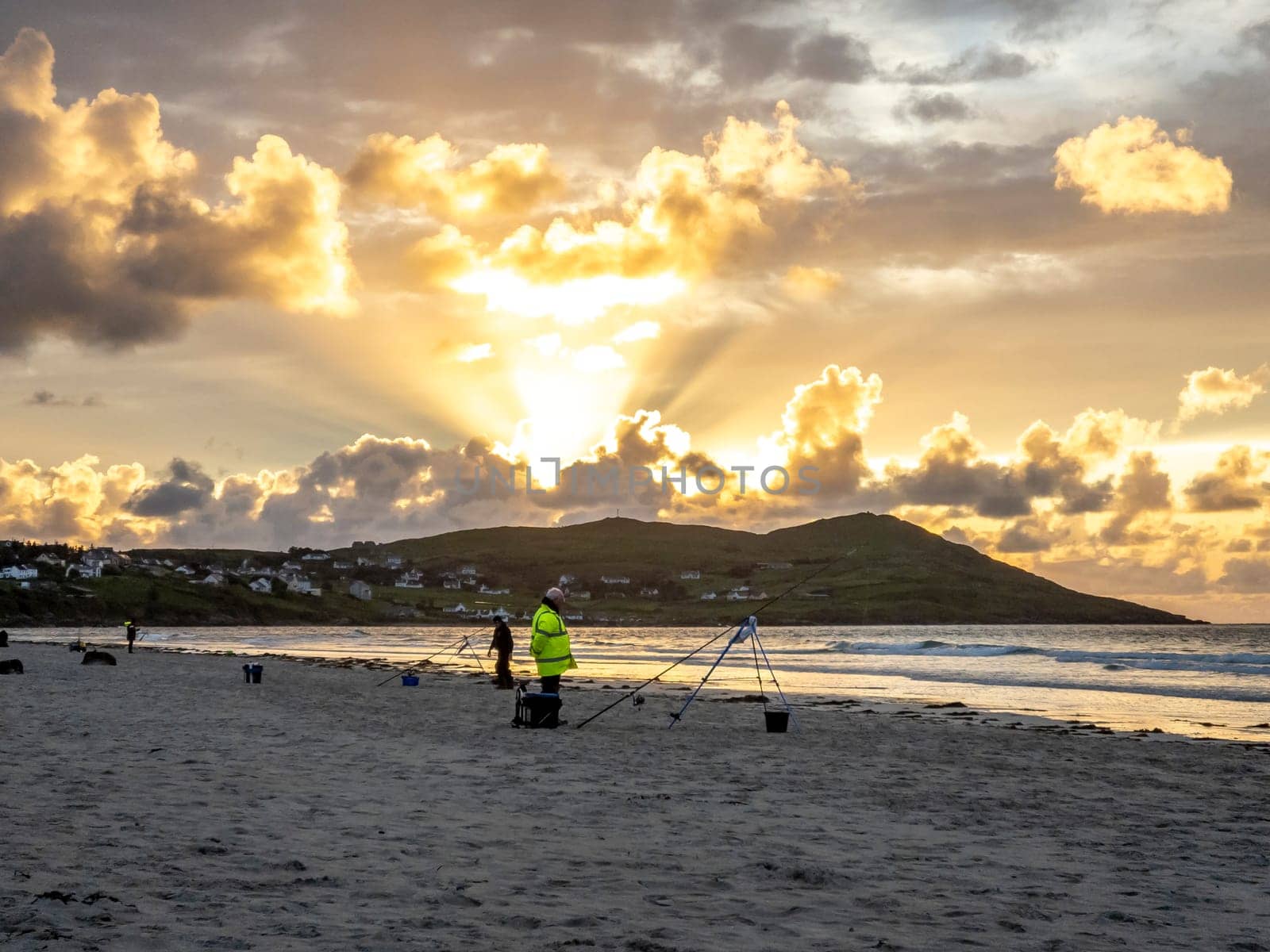 20 man are competing in a fishing competition on the beach