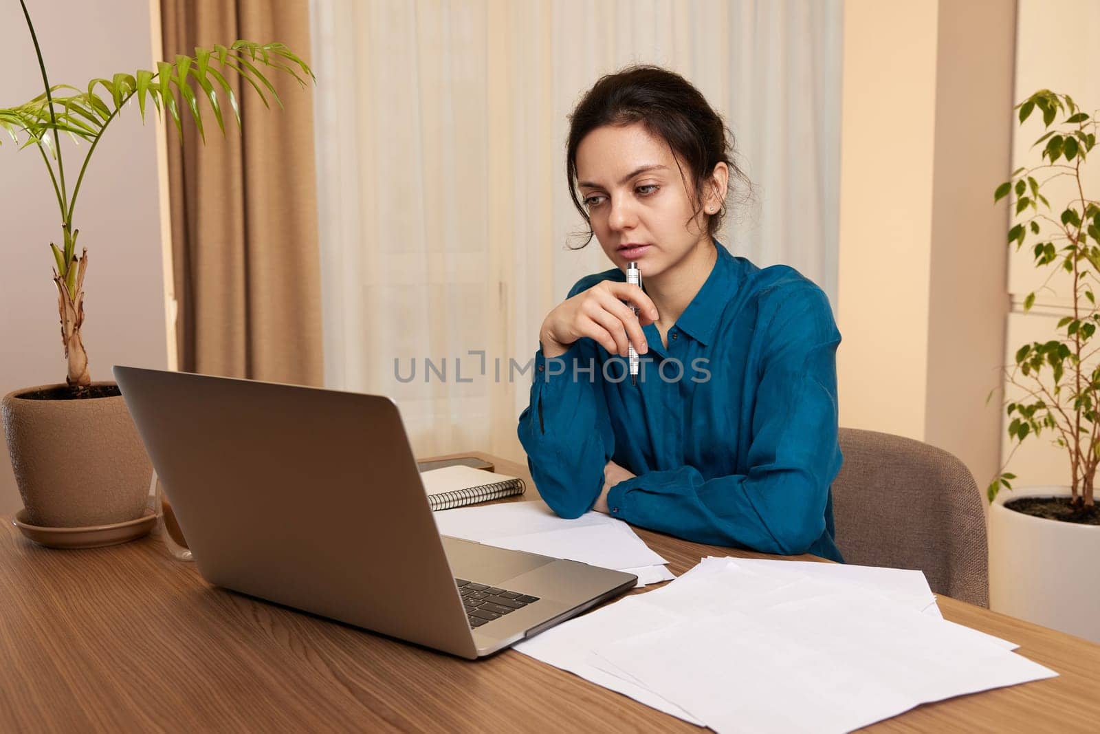 pretty calm woman using laptop at home by erstudio