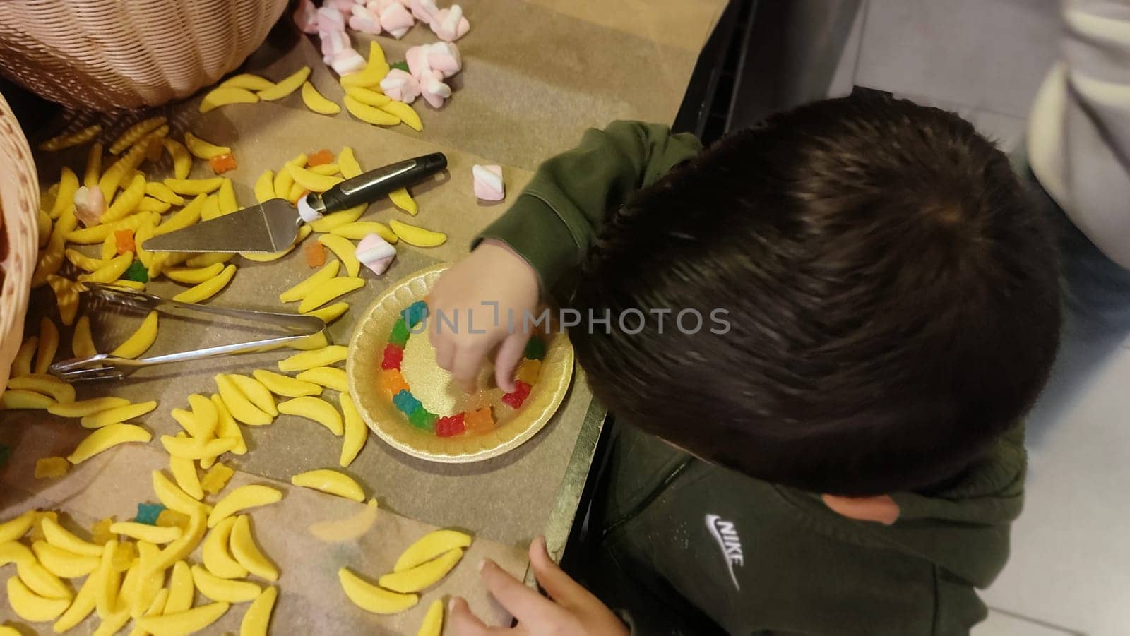 hands child boy playing with yellow candy. High quality photo