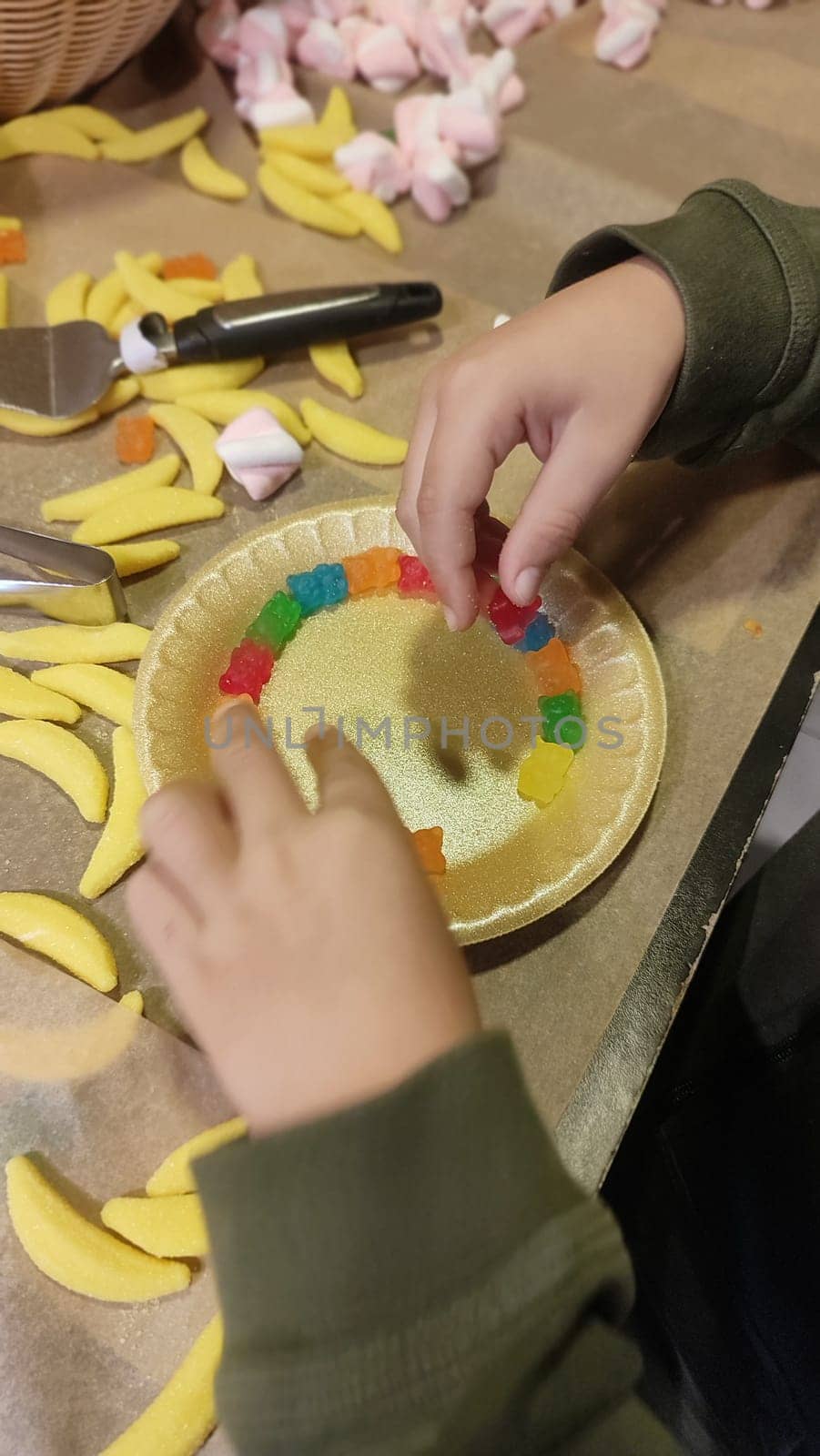 hands child boy playing with yellow candy. High quality photo