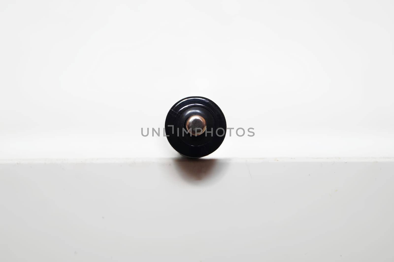 Single AAA-Size Battery Upright on a White Surface