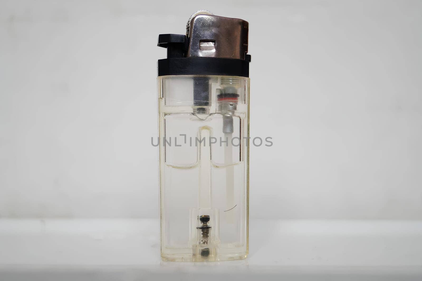Transparent Lighter Against a White Background Showcasing Its Inner Mechanism