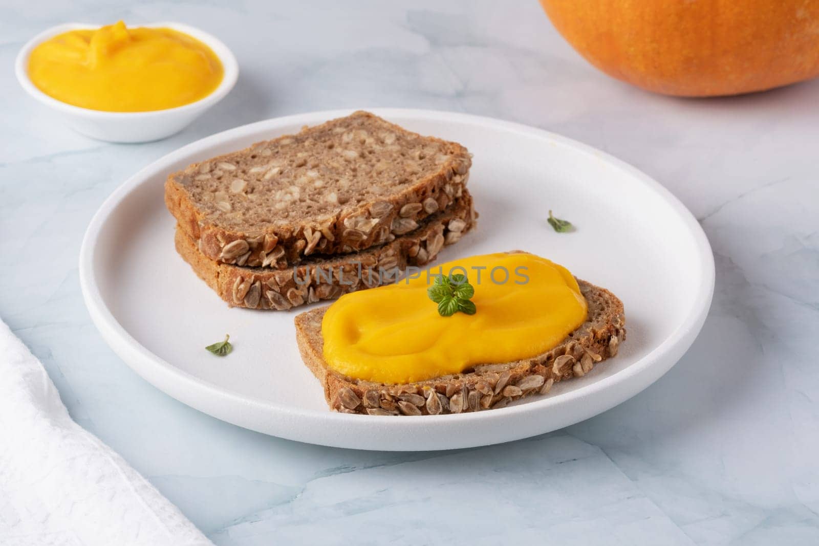 Sandwich with tasty pumpkin jam on table.