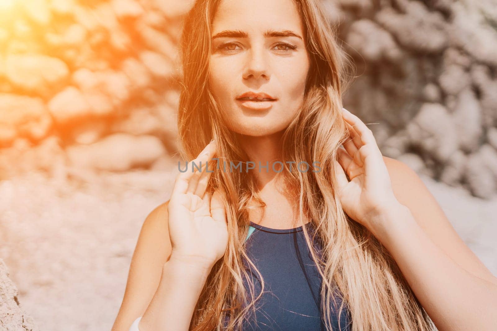 Woman travel sea. Young Happy woman in a long red dress posing on a beach near the sea on background of volcanic rocks, like in Iceland, sharing travel adventure journey