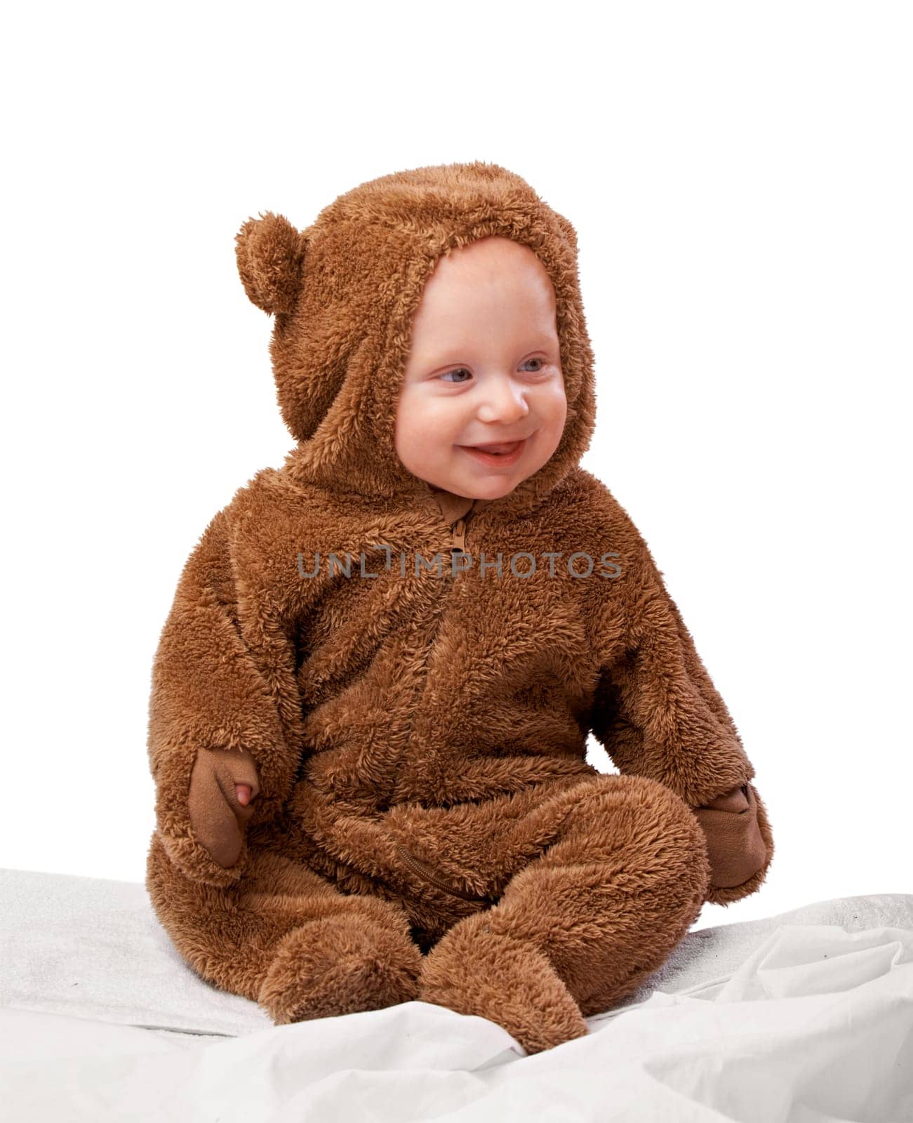 Studio, baby and onesie with costume, bear and toddler with joy and fun. Child, newborn and happiness with adorable, comfort and dressed up infant for development isolated on white background.