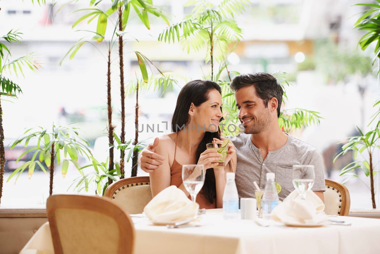 Couple, restaurant and drinks with lunch, love and romance for anniversary or celebration. Woman, man and date with luxury, fine dining and smile for relationship on holiday or vacation with meal.