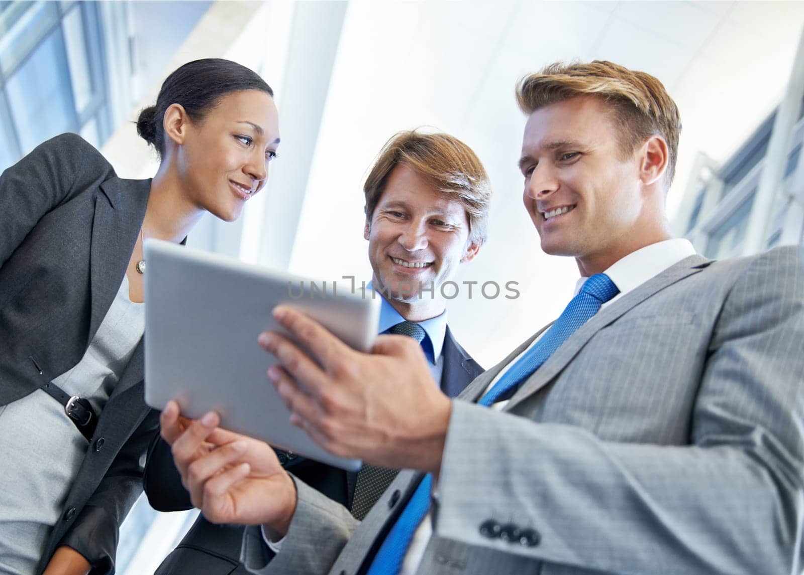 Business people, tablet and communication for project in office, collaboration and unity for proposal. Coworkers, workplace and teamwork for reading a report, support and discussion or networking.