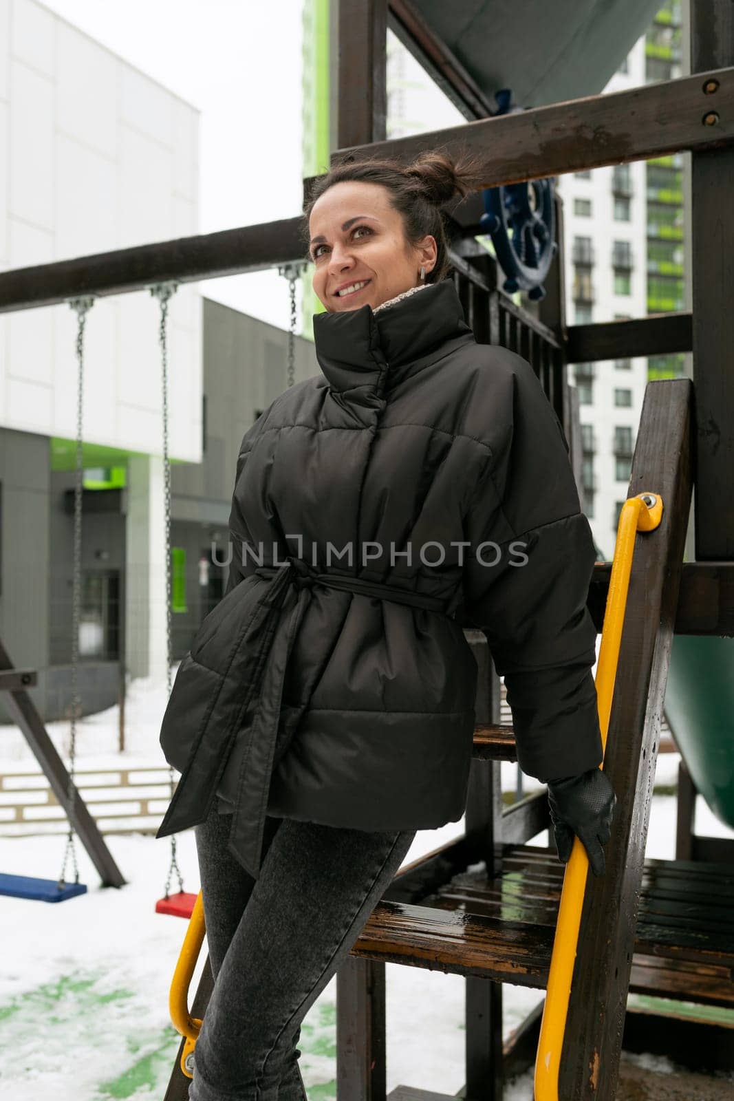 Fun concept, young woman having fun while on the playground in winter.