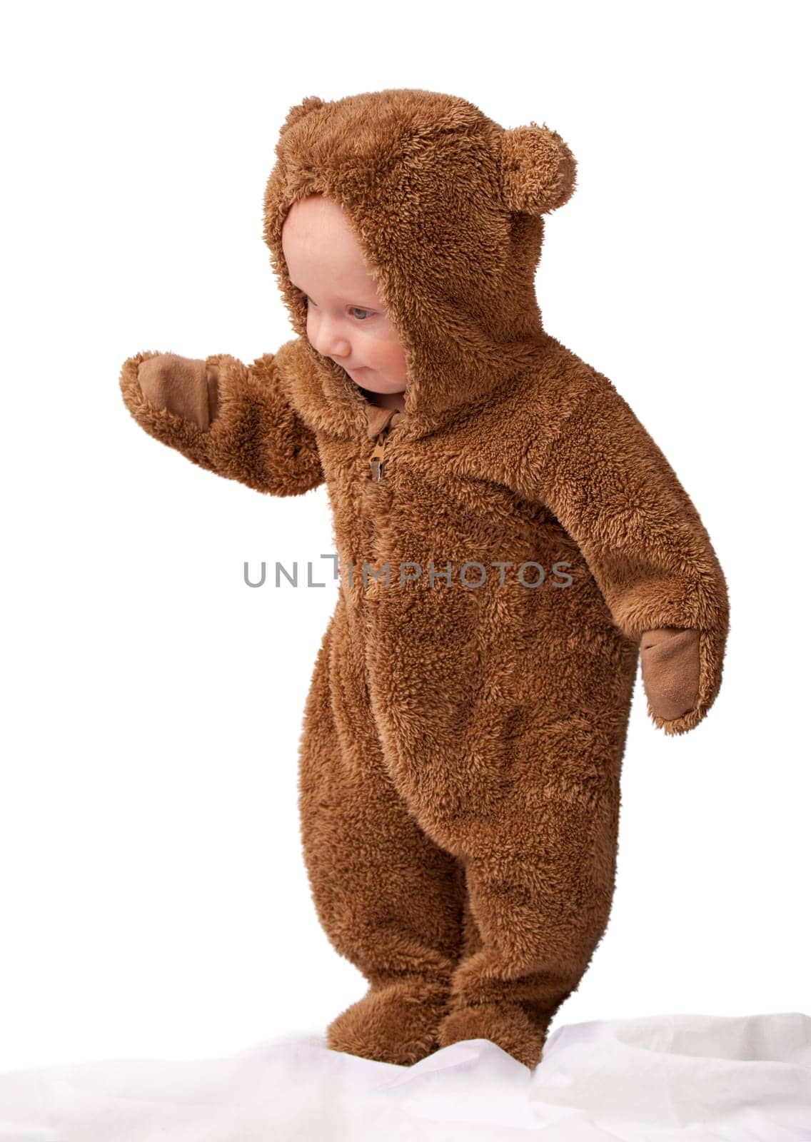 Studio, baby and onesie with costume, bear and toddler with joy and fun. Child, newborn and happiness with adorable, comfort and dressed up infant for development isolated on white background.