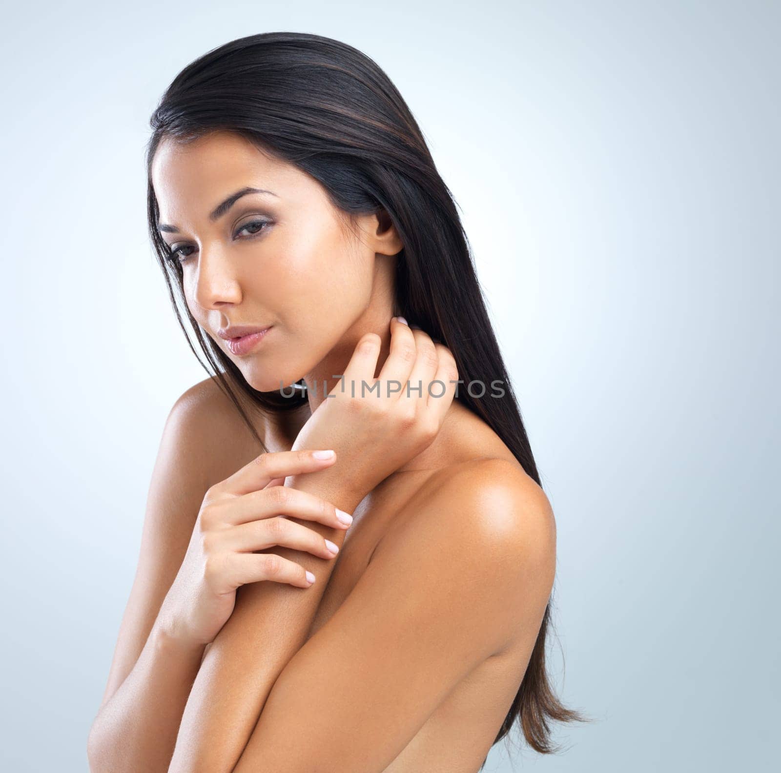 Woman, hair and beauty with cosmetics in studio, dermatology and wellness with keratin treatment on grey background. Haircare, shampoo and texture with growth, self care and cosmetology for shine.