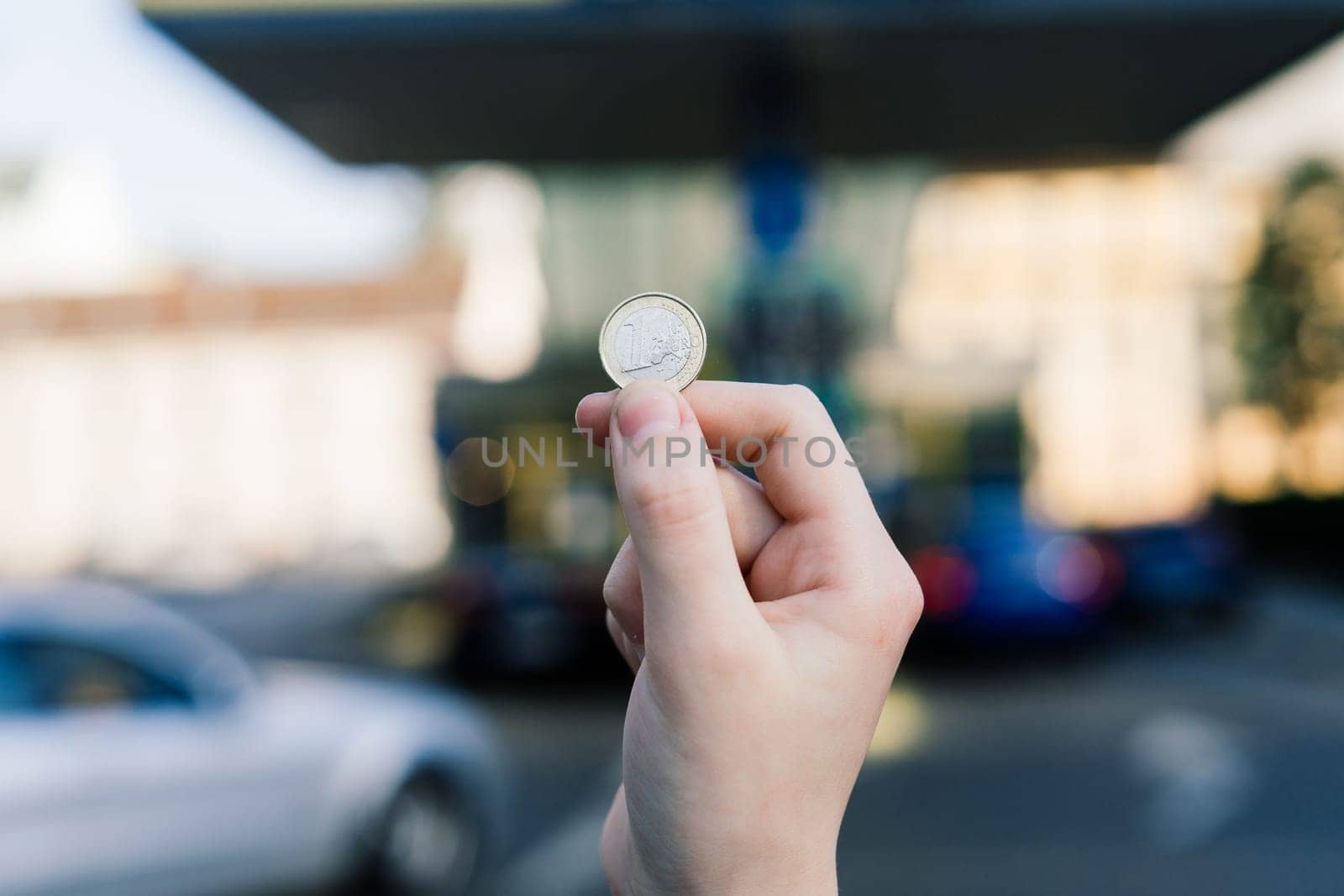 Euro coin and refueling of a car at gas station in city, expensive fuel oil