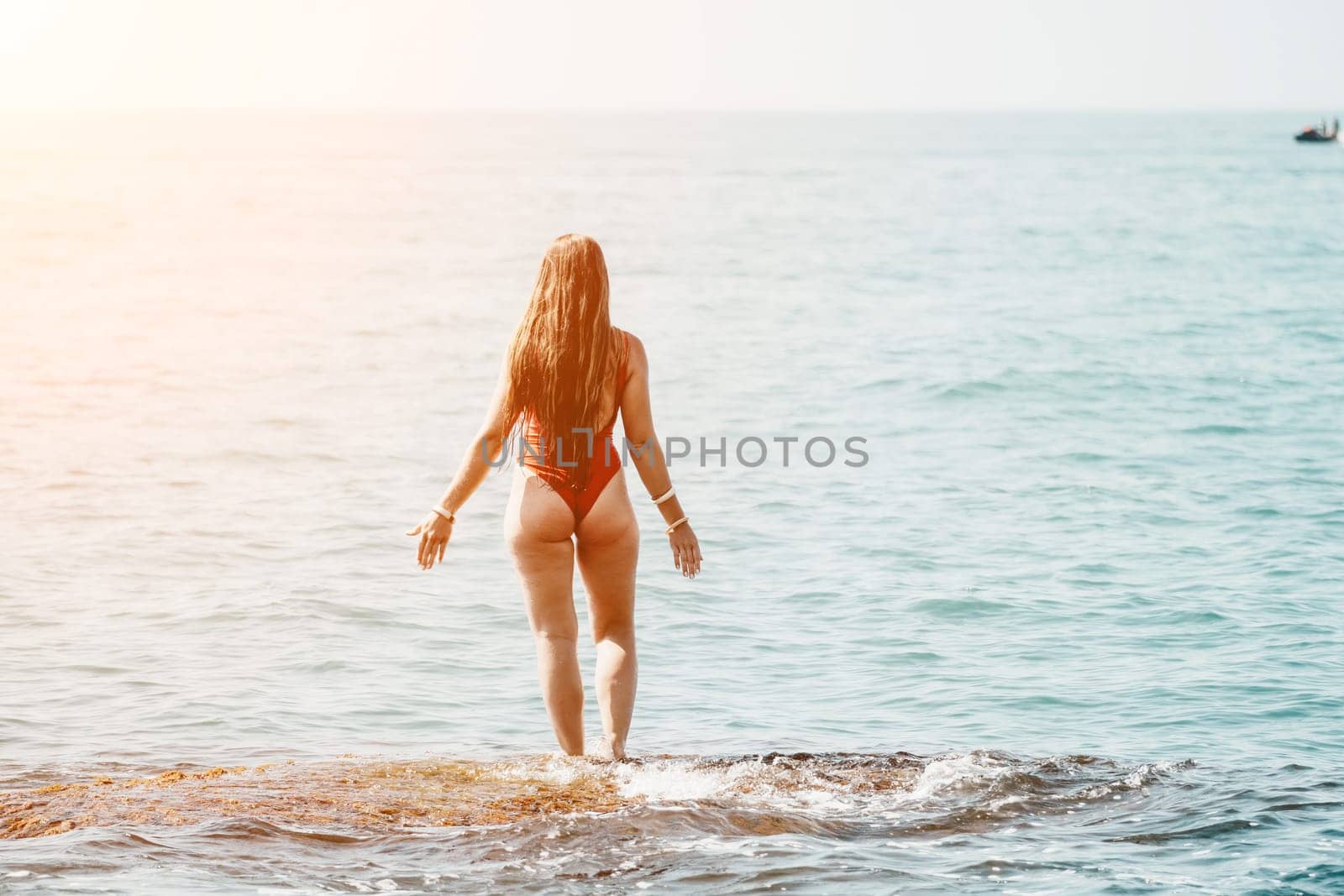 Woman sea yoga. Happy woman meditating in yoga pose on the beach, ocean and rock mountains. Motivation and inspirational fit and exercising. Healthy lifestyle outdoors in nature, fitness concept. by panophotograph