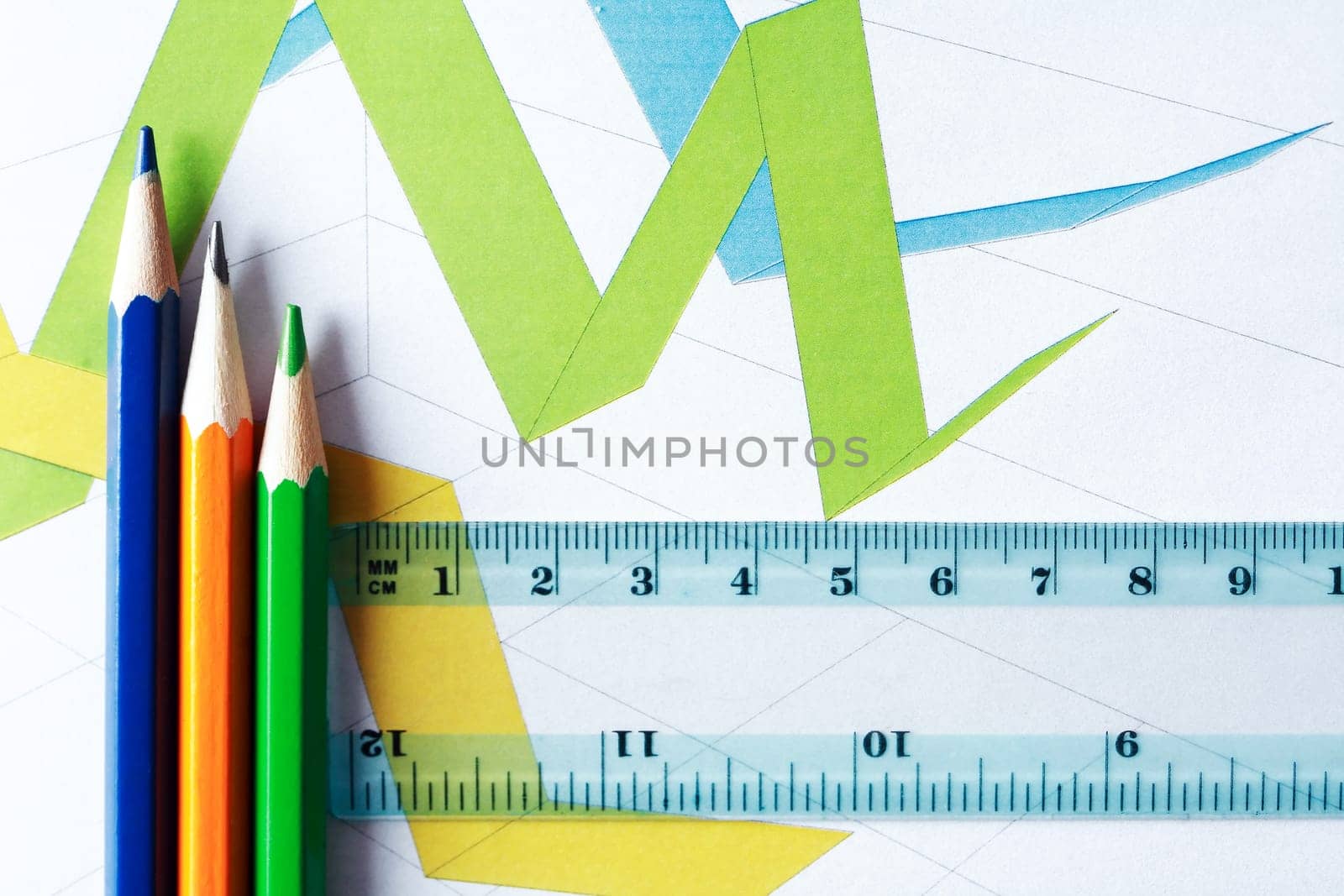 Business concept. Colored pencils and ruler on the background of the diagram