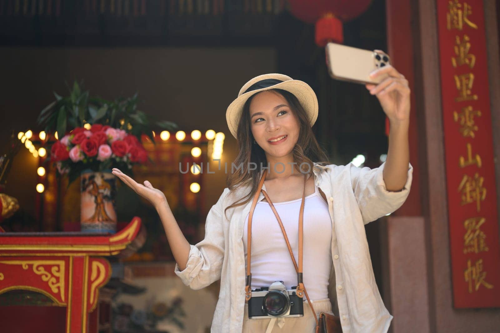 Happy young woman tourists taking a selfie at Chinese Temple in Chang Mai Thailand by prathanchorruangsak