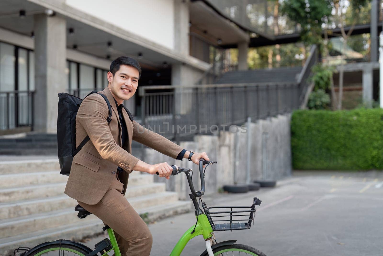 The businessman eco friendly transportation, cycling through the city avenues to go to work. sustainable lifestyle concept by nateemee