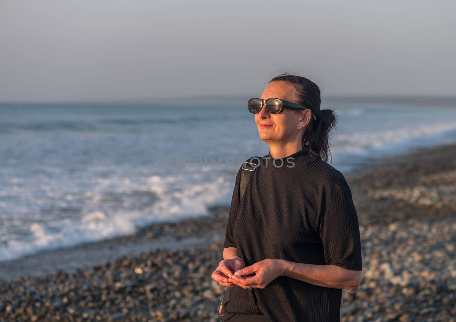 woman walking on the Mediterranean sea in winter at sunset 2